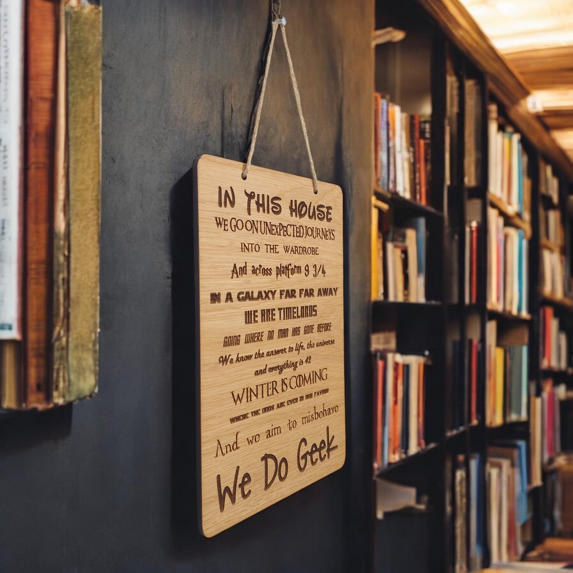 In This House We Do Geek wooden hanging sign.