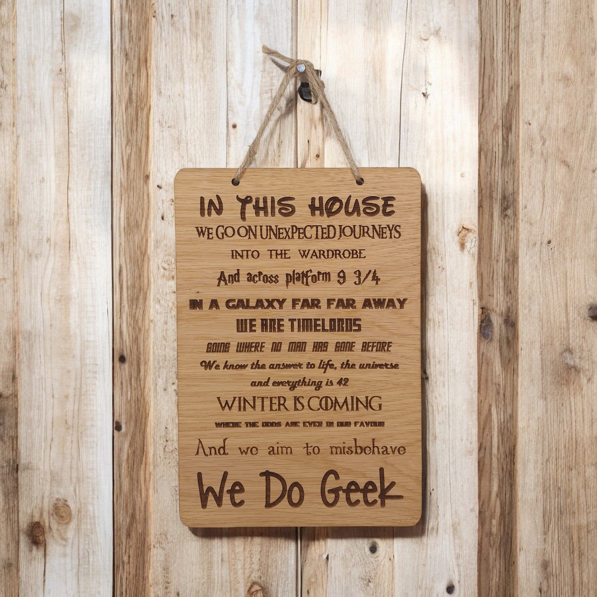In This House We Do Geek wooden hanging sign.